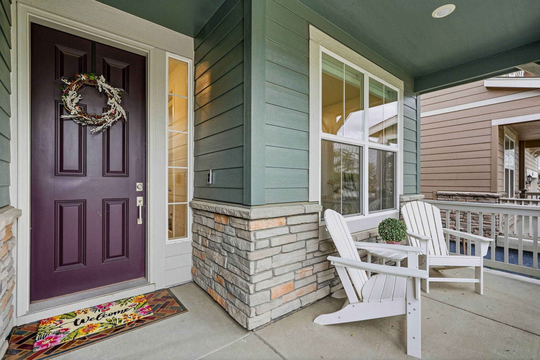 covered front porch seating at Erie CO home for sale